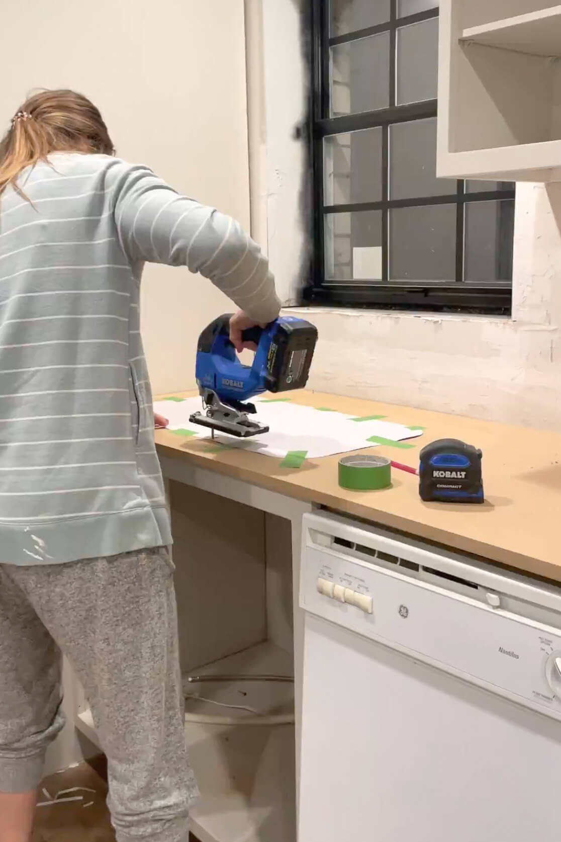 Cutting a hole in a countertop to install a sink.